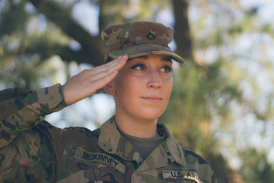 Close-up of soldier saluting outdoors