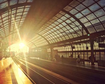 Train at railroad station in city against sky