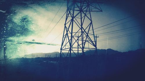 Low angle view of electricity pylon against sky