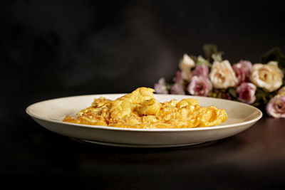 Close-up of food served on table against black background