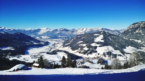 Scenic view of snowcapped mountains against clear blue sky