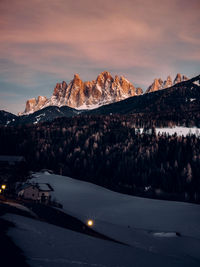 Scenic view of snowcapped mountains against sky during sunset