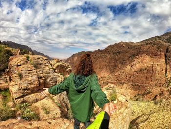 Rear view of woman standing on mountain