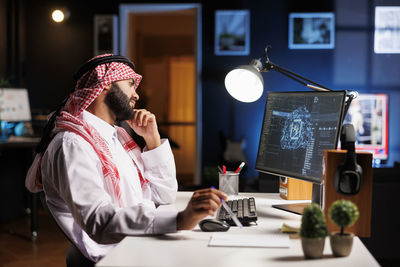 Midsection of businessman working at desk in office