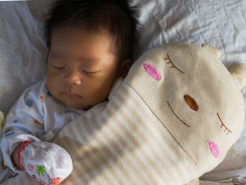 Close-up of asian baby sleeping in bed 