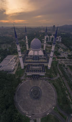 High angle view of buildings against cloudy sky