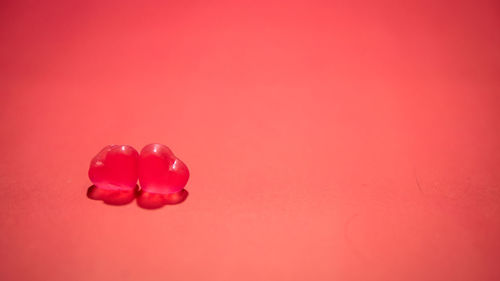 Close-up of heart shape against pink background