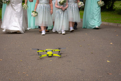 Drone on road with bridesmaid in background