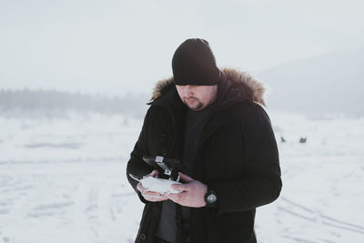 Drone operator outdoors in snow