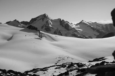 Scenic view of snowcapped mountains against clear sky