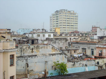 Buildings in city against clear sky