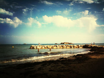 Scenic view of sea against cloudy sky