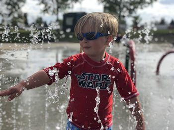 Full length of boy standing by water