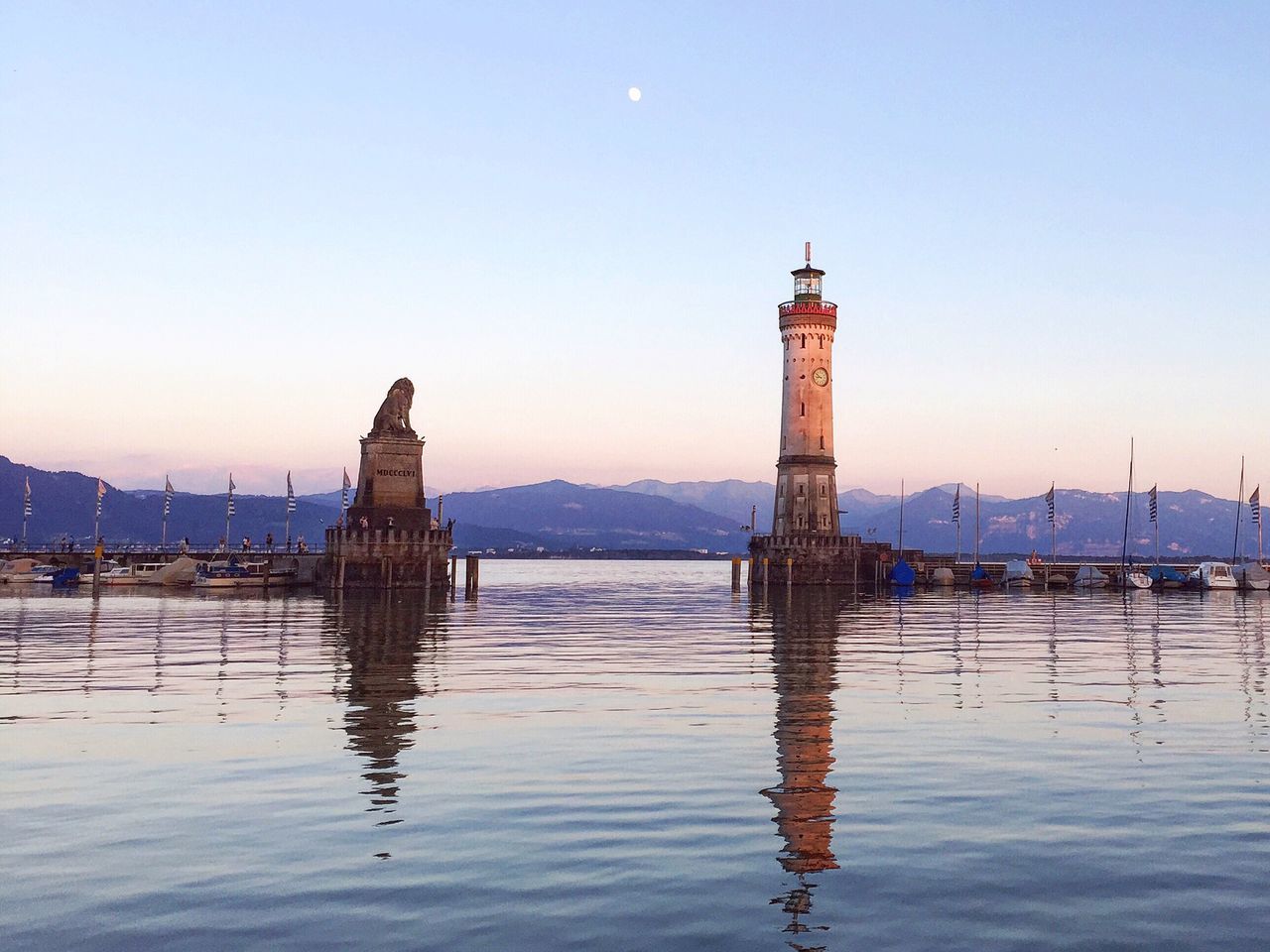 architecture, built structure, water, building exterior, clear sky, reflection, tower, waterfront, blue, tranquility, travel destinations, tranquil scene, history, tall - high, outdoors, scenics, nature, no people, famous place, tall, monument