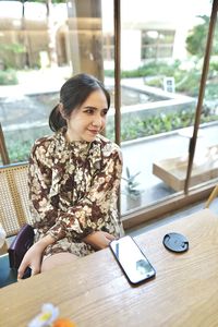 Young woman sitting on table