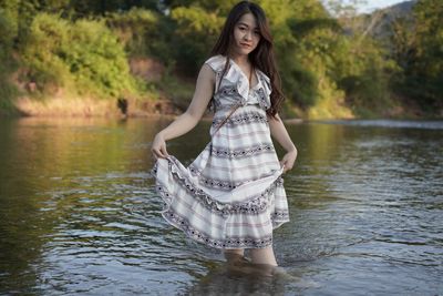 Young woman standing in lake