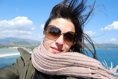 Portrait of woman wearing sunglasses against sky