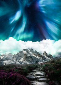 Scenic view of snowcapped mountains against sky at night