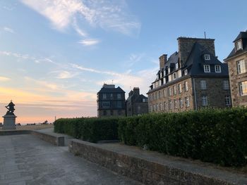 Buildings against sky during sunset