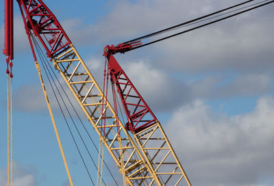 Low angle view of electricity pylon against sky