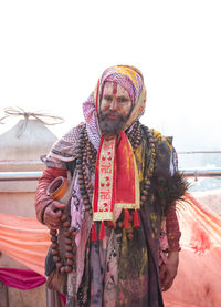 Portrait of man with multi colored umbrellas