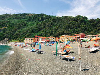 Scenic view of beach by buildings against sky