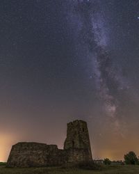 Low angle view of castle against sky at night