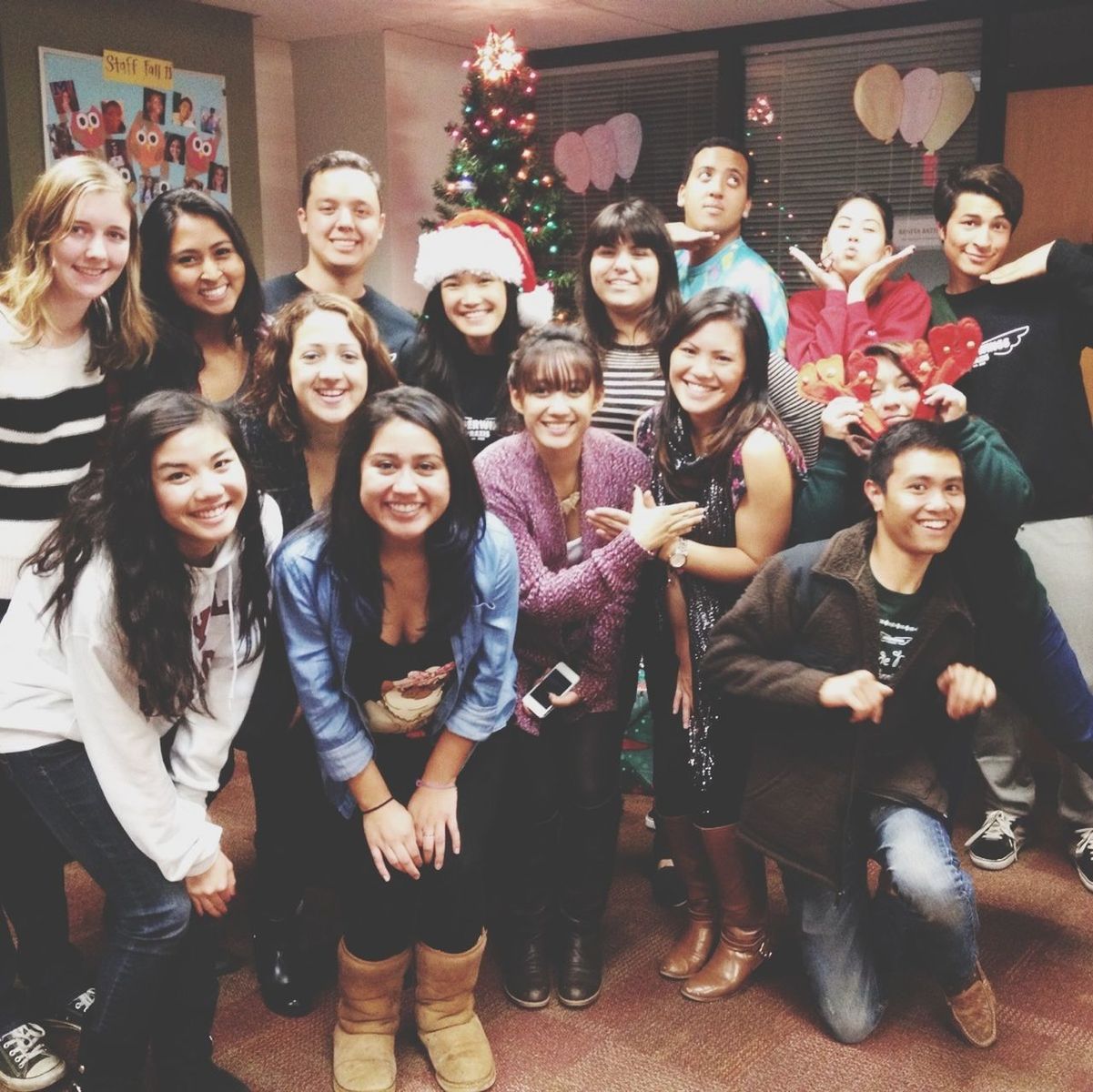 indoors, lifestyles, togetherness, leisure activity, happiness, celebration, portrait, front view, looking at camera, person, smiling, large group of people, illuminated, cultures, standing, tradition, young women, fun, human representation