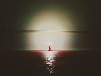 Silhouette person standing in sea