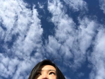 Woman looking away against sky