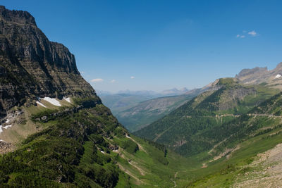 Scenic view of mountains against blue sky