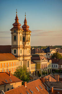 View of buildings in city at sunset