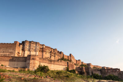 Low angle view of rock formation against clear sky