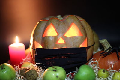 Close-up of illuminated pumpkin against black background