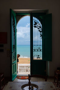 Boy peeking through doorway