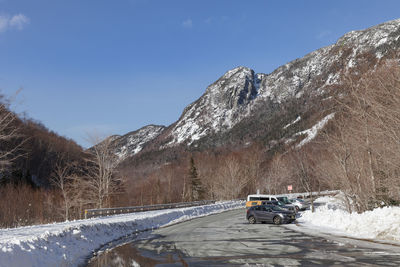 Car on snowcapped mountain against sky