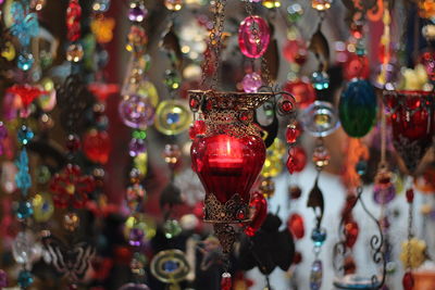 Close-up of decorations hanging in market for sale