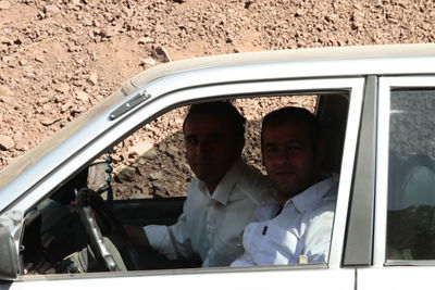 Man sitting in car window