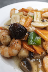 Close up of an oriental plate of chop suey with prawns