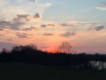 Scenic view of landscape against sky at sunset