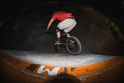 Rear view of man riding bicycle