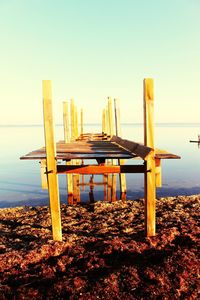 Pier on sea against clear sky