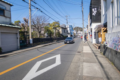 Cars on road by buildings in city