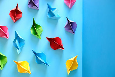 High angle view of multi colored umbrellas against blue background