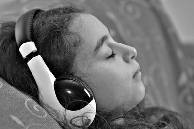 Close-up portrait of woman lying on bed