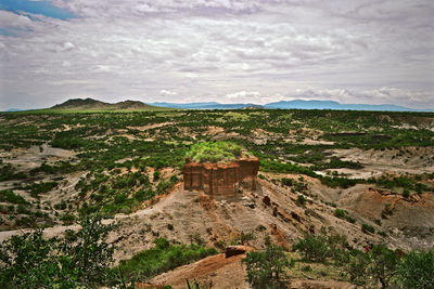 Scenic view of landscape against cloudy sky