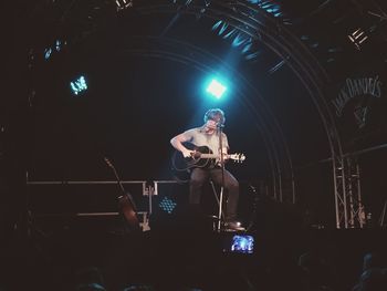 Low angle view of two people at concert
