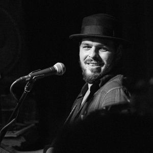 Smiling male singer wearing hat