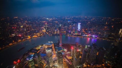 High angle view of illuminated city buildings at night