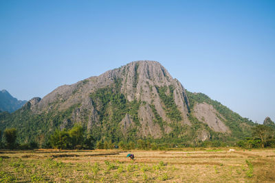 Scenic view of mountains against clear blue sky